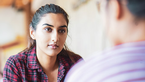 Close view of a worker having a serious discussion with a client