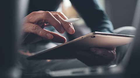 A close view of a person accessing information on a tablet device