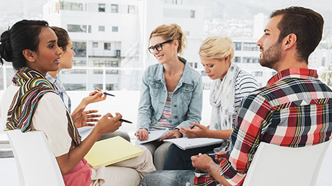 A group of workers discussing policies and procedures