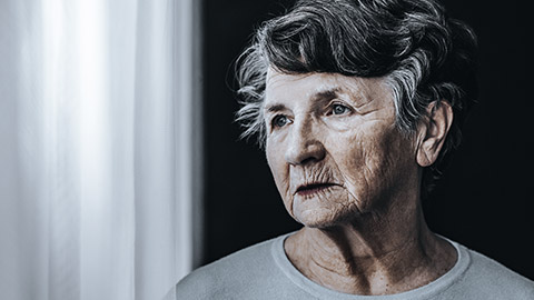 Close-up of an elder woman looking outside