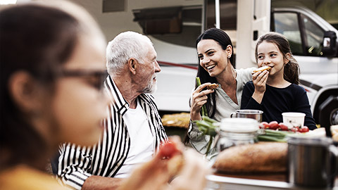 A family with different generations eating outdoors together