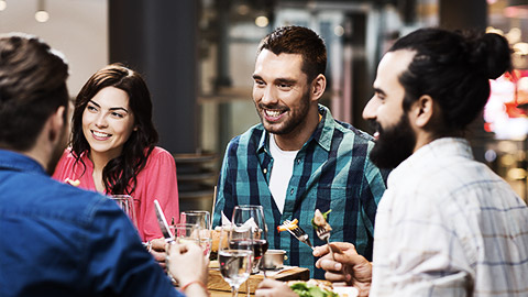 A group of adults eating together