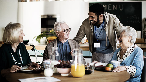 A group of elderly being assisted by a nurse