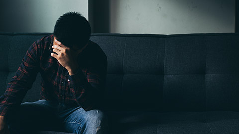 A stressed out worker sitting on a couch