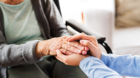 A support worker comforting an elderly client