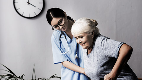 A nurse helping an elder