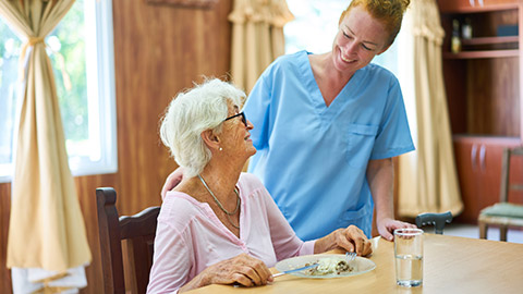 A carer and client in an aged care facility