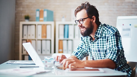 A project manager in an office working on construction project planning software