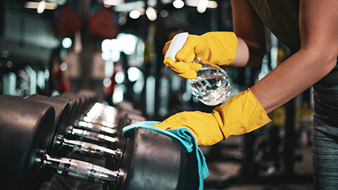 Close view of gym equipment being cleaned