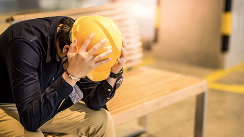 Construction worker feeling overworked and experiencing depression