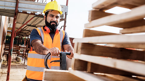 Image-Substitution-Photo of Construction Worker Utilising A Manual Handling Trolly