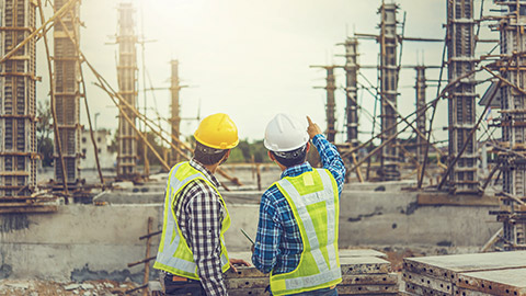 Two construction workers conducting a construction site risk assessment