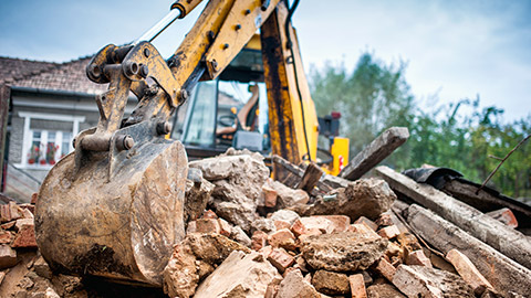 A close view of an excavator digging up an old site, in preparation for new construction