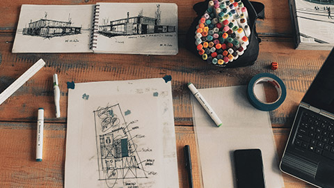 A group of concept drawings on a desk