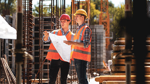 2 construction managers on a site discussing plans