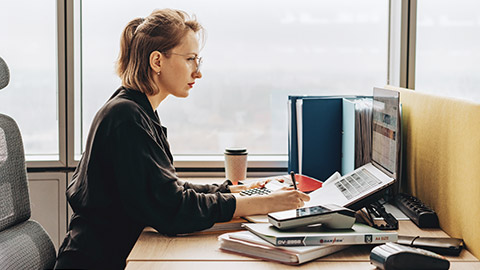 A bookeepper working on a computer at a desk