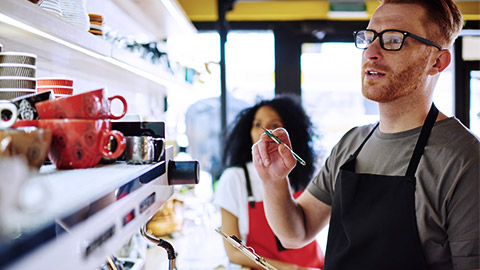 Man doing inventory on kitchen goods