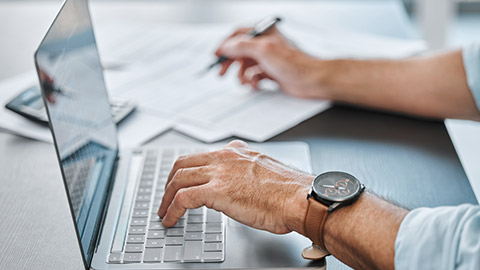 A close view of a person typing a laptop