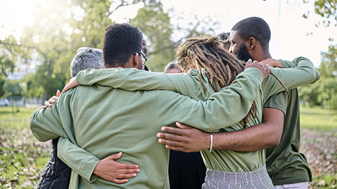 Group hug, support and people in park for eco friendly, sustainable or community service project, teamwork or love.