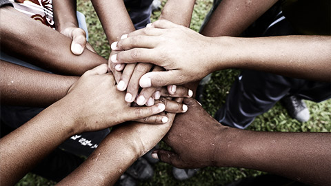 A diverse group of hands together