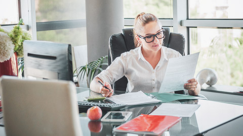 A business person reading paperwork in a modern office