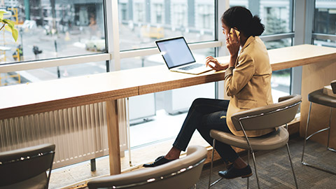 A business manager reviewing files on a laptop