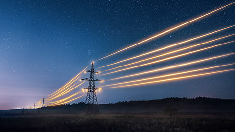 Electricity transmission towers with orange glowing wires the starry night sky