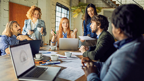 Team meeting of young diverse professionals in office