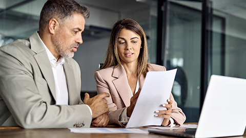 two professional executives experts discussing financial accounting papers working together