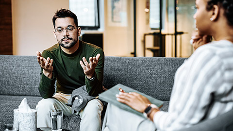 sad man talking with support worker