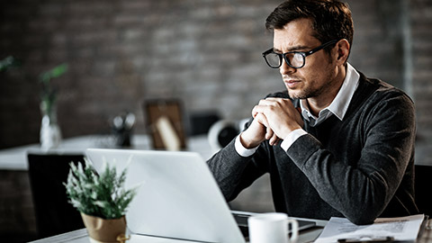 man reading on a computer