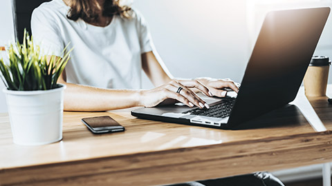 crop image of woman working with computer