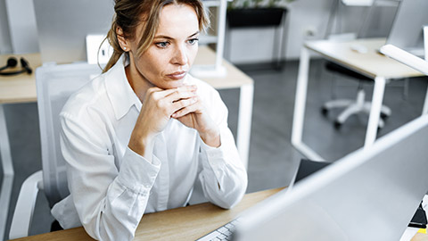 serious woman looking the computer screen