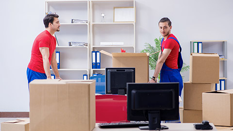 Two employees moving personal belongings