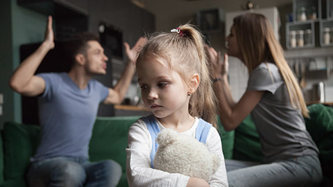 Kid daughter feels upset while parents fighting at background