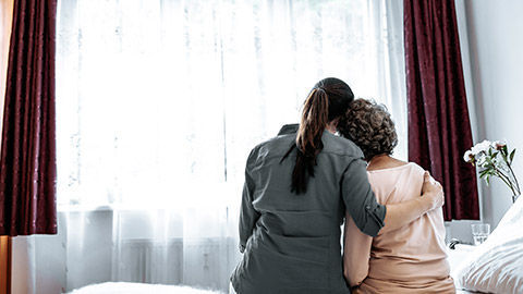 nurse hugging elder