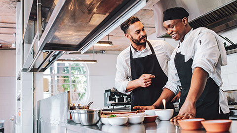 A business owner sharing a joke with an employee