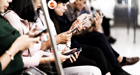 People using their phones in a train