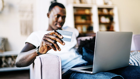 a business person ready to use their credit card through a laptop