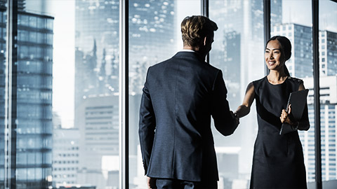 Female and Male Business Partners Meet in Office