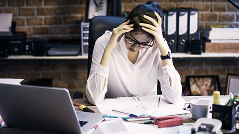 A person looking at a lot of financial papers