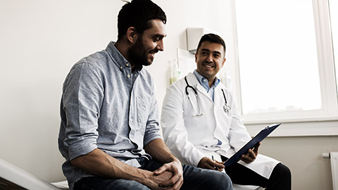 A person talking to a hospital assistant