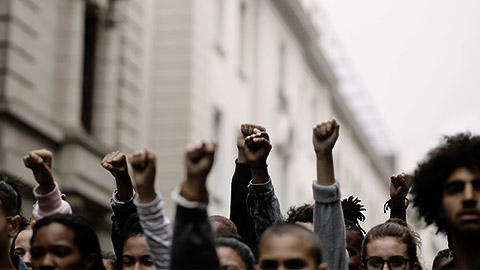 A grup of people with fists held high