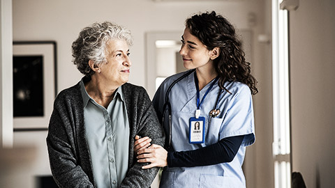 A carer holding the arms of a client