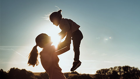 A perso carrying and playful with a child