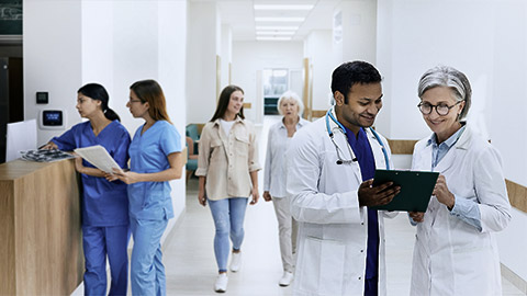 A nurse walking with a patient in a hospital floor