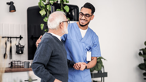 A carer helping out and elderly