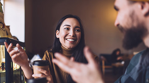 A close view of 2 colleagues sharing information in a casual setting