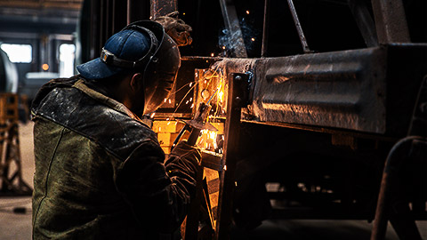 a welder working on caravan a chassis