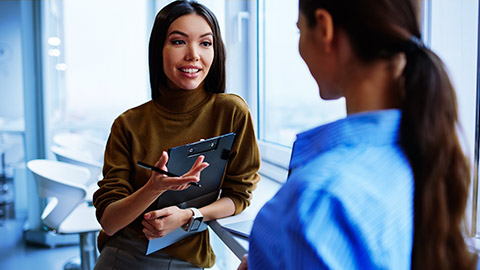 two colleagues discussing being selected for employment